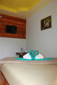 a bed in a room with at Huensala Homestay in Ban Wang Khon