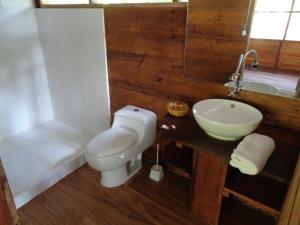 a bathroom with a toilet and a sink at Tambopata River in Puerto Maldonado