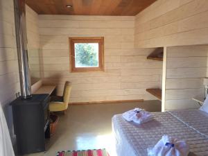 Una habitación con una cama y un escritorio y una ventana. en La melliza, en San Carlos de Bariloche