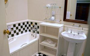 
a bathroom with a sink, toilet and bathtub at Wild Olive Guest House in Cape Town
