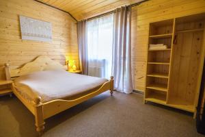 a small bedroom with a bed and a window at Adelis in Yaremche