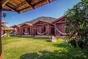 a house with hammocks in the yard at Green Mountain Pousada in Florianópolis