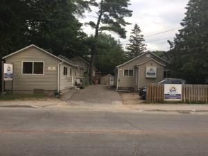 a row of houses on the side of a street at Wasaga Bridge Cottages in Wasaga Beach