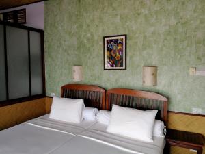 Postel nebo postele na pokoji v ubytování Sala Done Khone Hotel