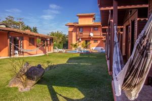 a yard with a hammock and a house at Green Mountain Pousada in Florianópolis