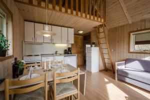 a kitchen and dining room with a table and chairs at Bryrup Camping in Bryrup