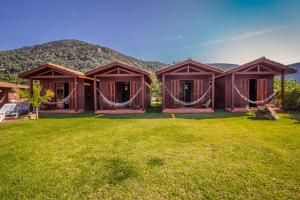 a house with a large yard in front of a mountain at Green Mountain Pousada in Florianópolis