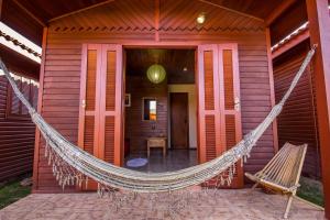 a hammock hanging from the front of a house at Green Mountain Pousada in Florianópolis