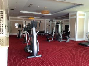 a gym with treadmills and ellipticals on a red carpet at Nha Trang Apartment - Unit 3706 in Nha Trang