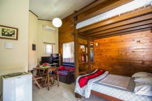 a bedroom with a bunk bed and a desk and a table at Green Mountain Pousada in Florianópolis
