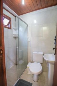 a bathroom with a toilet and a shower and a sink at Green Mountain Pousada in Florianópolis