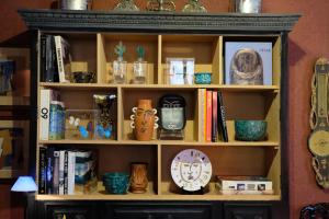 a book shelf filled with lots of books at La Maison du Frene in Vence