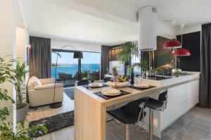 a kitchen with a large island in the middle of a room at Residence Alpha Apartments in Cavtat