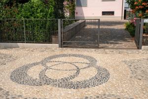 a mosaic of a snake on a sidewalk at Dolce Casetta in Faenza