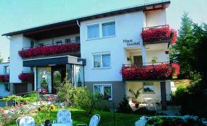 a large building with flowers on the balconies and plants at Pension Gockels-Auszeit in Bad Wildungen