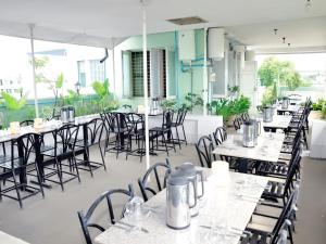 a row of tables and chairs in a restaurant at A.D.1Hotel in Mandalay