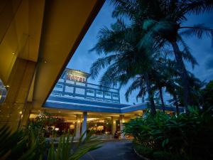 a building with a palm tree in front of it at Istana Nelayan Hotel in Tangerang