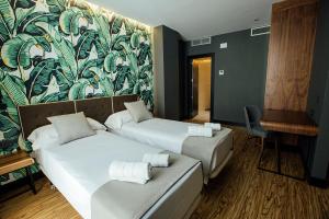 Posteľ alebo postele v izbe v ubytovaní Málaga Premium Hotel