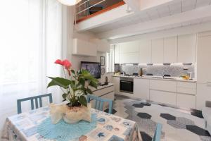 a kitchen with a table with a plant on it at Desy's House in Minori