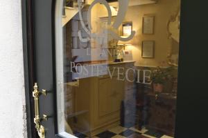 a glass door with a sign that reads home price preserve at Locanda Poste Vecie in Venice