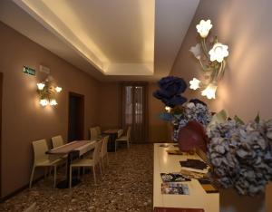 a restaurant with tables and chairs and a vase of flowers at Locanda Poste Vecie in Venice