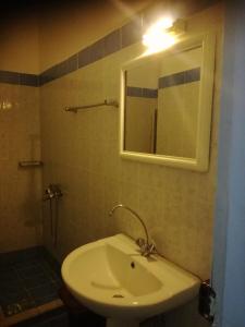 a bathroom with a white sink and a mirror at Elite Hotel in Athens