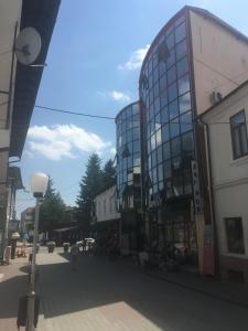 a city street with a glass building on a street at SkyRoomsHorezu in Horezu