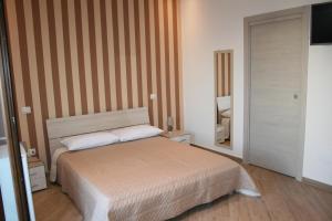 Ένα ή περισσότερα κρεβάτια σε δωμάτιο στο Il Fenicottero