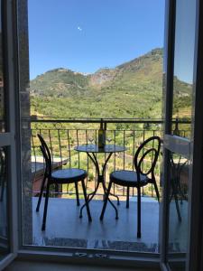 a table and chairs on a balcony with a view at Sandra Villa Rooms in Corniglia