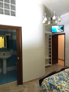 a room with a bed and a sink and a mirror at Etna Vintage in Linguaglossa