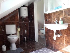 a bathroom with a toilet and a sink at Apartmani Timon in Bol +27 photos