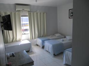 מיטה או מיטות בחדר ב-Hotel Amazonas