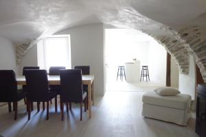 a dining room with a table and chairs at Très bel appartement, Parc national des Écrins, piscine et terrasse in Les Vigneaux