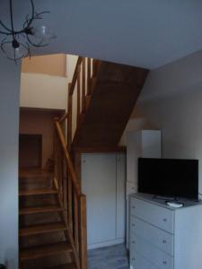 a living room with a staircase and a television at Volissos Homes in Volissos