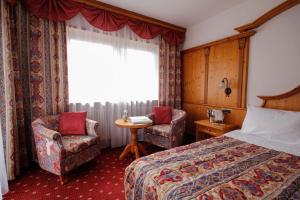 Postel nebo postele na pokoji v ubytování Hotel Alpi