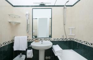 a bathroom with a sink and a mirror at Hotel Bellavista in Anacapri