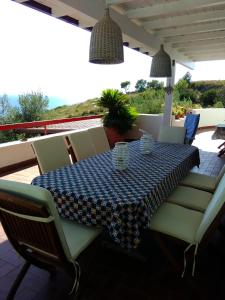 een tafel met stoelen en een blauw en wit tafelkleed bij Resort Luna Rossa in Sperlonga