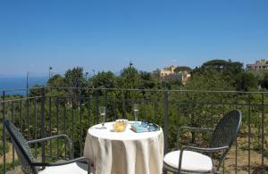 a table and chairs on a balcony with a view at Hotel Bellavista in Anacapri