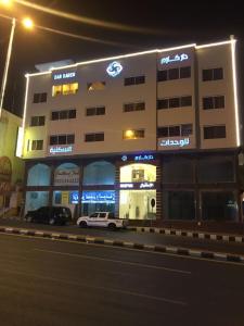 a building with a car parked in front of it at Dar Karim in Abha