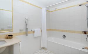 a white bathroom with a shower and a sink at Hotel Bellavista in Anacapri