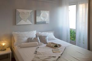 a white bed with towels and a box on it at Apartment Lana in Split