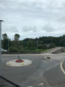 an empty parking lot with a fountain in the middle at Buchan Hotel in Ellon