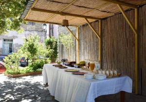 a white table with food on it under a pavilion at Hotel Διεθνές in Zacharo