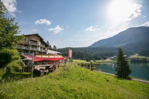 a hotel with a view of a lake and mountains at Hotel Seebüel in Davos