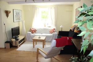 a living room with a white couch and a window at Schräges Haus in Treis-Karden