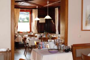 a dining room with white tables and chairs at Gasthof Linde in Bregenz
