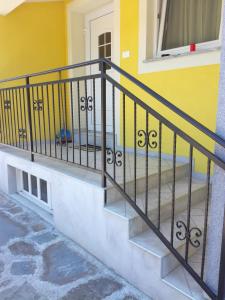 a stair railing in front of a yellow house at Sončne Terase in Piran