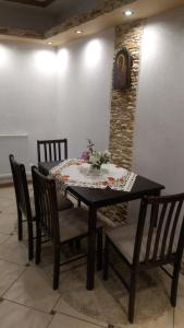 a dining room table and chairs with flowers on it at Apartament U Janusza in Nowy Targ