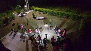 a group of people standing around a garden at night at 好宿民宿 in Jinning