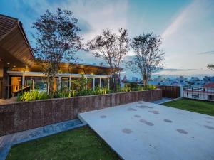 a house with a patio and a yard with trees at Mai's Boutique in Danang